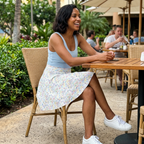 Autograph skirt seated at resort cafe