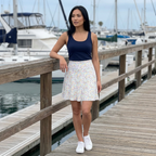 Autograph skirt standing on marina boardwalk