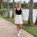 Autograph skirt walking beside resort lake