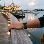 Black festive watchband with waterfront carousel lights and fireworks