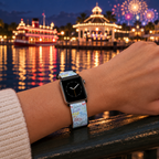 Blue autograph watchband beside an illuminated waterfront bandstand