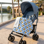 Blue Checkerboard Donald blanket on a stroller beside a park lake