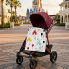 Castle Celebration blanket on a burgundy stroller with a castle backdrop