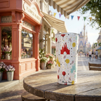Castle Celebration tumbler outside a coral Victorian storefront
