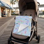 Character Autographs on Blue blanket on a stroller along a resort boardwalk