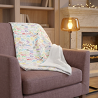 Character Autographs on White blanket on a mauve fireside chair
