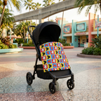 Checkerboard Mickey Hands blanket on a stroller in a retro park plaza
