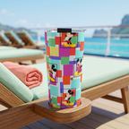 Colorblock Mickey tumbler on a cruise lounger overlooking tropical cliffs