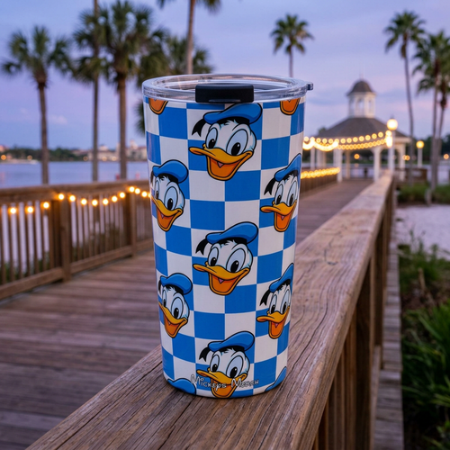 Donald tumbler overlooking a glowing waterfront pier pavilion