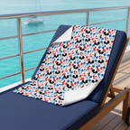 Emoji Mickey blanket on a navy-cushioned cruise lounge chair