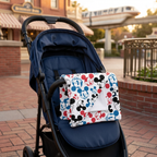 Emoji Mickey blanket on a navy stroller in a brick park plaza