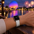 Epcot pattern watchband beside a lagoon with an illuminated sphere and fireworks