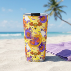 Figment tumbler photographed from sand level beside a lavender towel