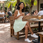 Green autograph skirt seated at resort cafe