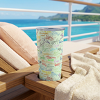Green Autographs tumbler on a cruise lounger overlooking a tropical coastline