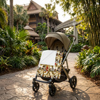 Jungle Camo Mickey blanket on a stroller along a tropical park walkway