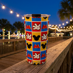Mickey Hands tumbler on an evening boardwalk under string lights