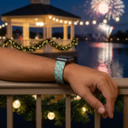 Mint festive watchband beside a glowing waterfront pavilion