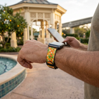 Orange bird-pattern watchband along a resort pathway