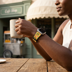 Orange bird-pattern watchband at a retro café
