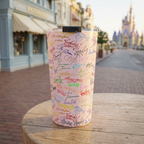Pink Autographs tumbler outside a pale blue Victorian patisserie