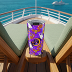 Purple Figment tumbler viewed diagonally from above on a cruise lounger
