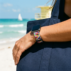 Rainbow-pattern watchband at a tropical beach