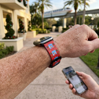 Red winter-scene watchband along a resort courtyard
