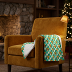Teal Checkerboard Pluto blanket on a mustard velvet fireside chair