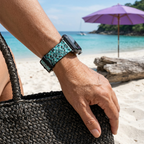 Teal icon-pattern watchband at a tropical cove