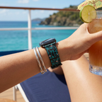 Watchband on a cruise deck overlooking an island coastline